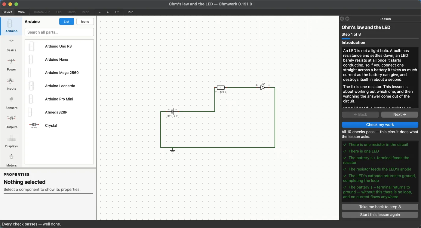 The first lesson finished: a battery, a 470 ohm resistor and an LED on the canvas, with the lesson panel showing all ten checks passing in green.